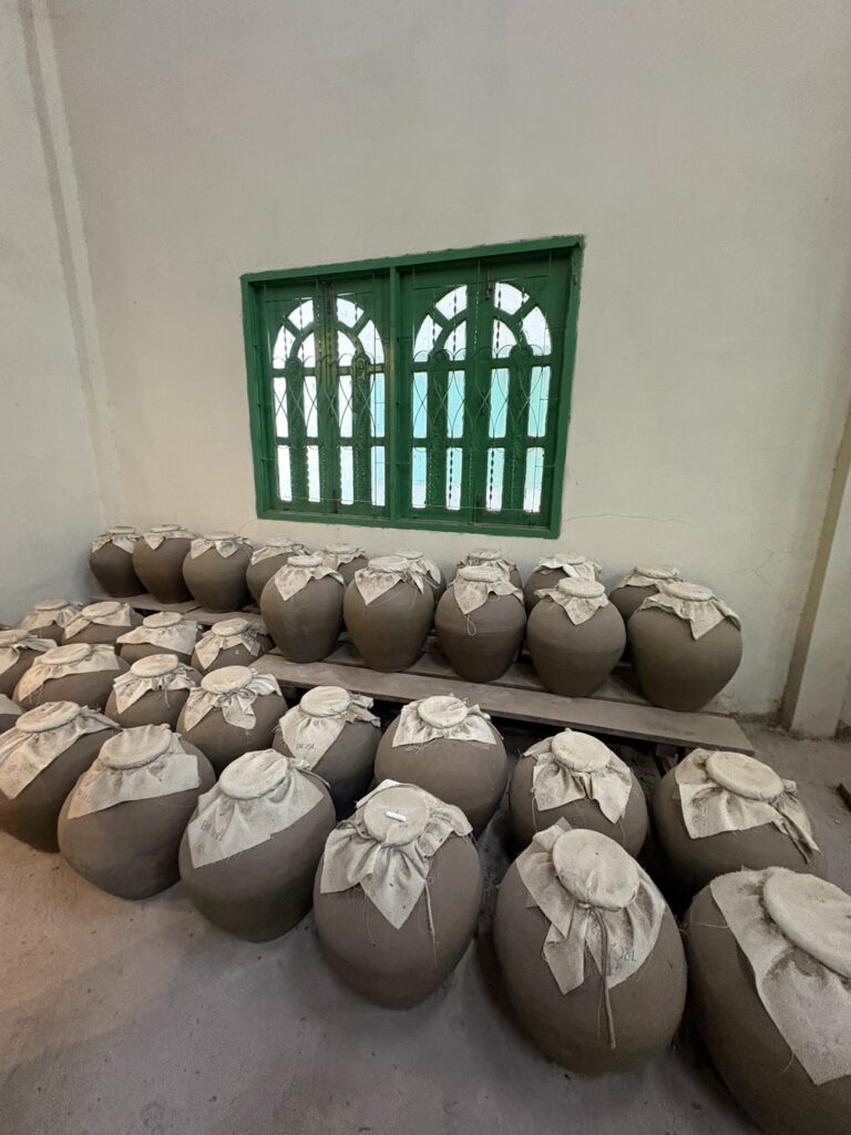 The traditional clay pot storage room at LAODI Distillery in Laos, where the initial batches of rum were aged, explored by expert Mika Tanimoto."