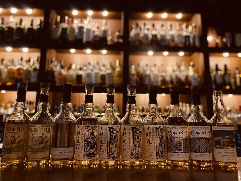 Over 1,000 bottles of Japanese whisky, showcasing rare craft labels like Saburomaru on the shelf.