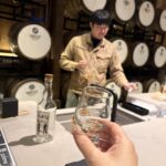 Japanese whisky expert Mika Tanimoto receiving a special dram from the President of Saburomaru Distillery in a private sanctuary behind a hidden door."