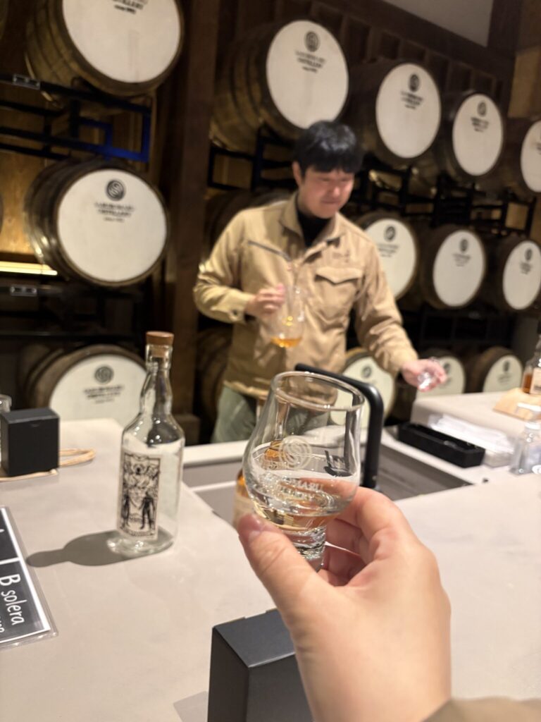 Japanese whisky expert Mika Tanimoto receiving a special dram from the President of Saburomaru Distillery in a private sanctuary behind a hidden door."