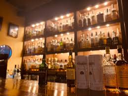 Massive collection of over 1,000 rare Japanese whiskies and rums at Bar Little Happiness Hiroshima, featuring hard-to-find craft labels.